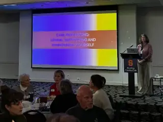 Speaker presenting at Empower Parkinson care partner education retreat